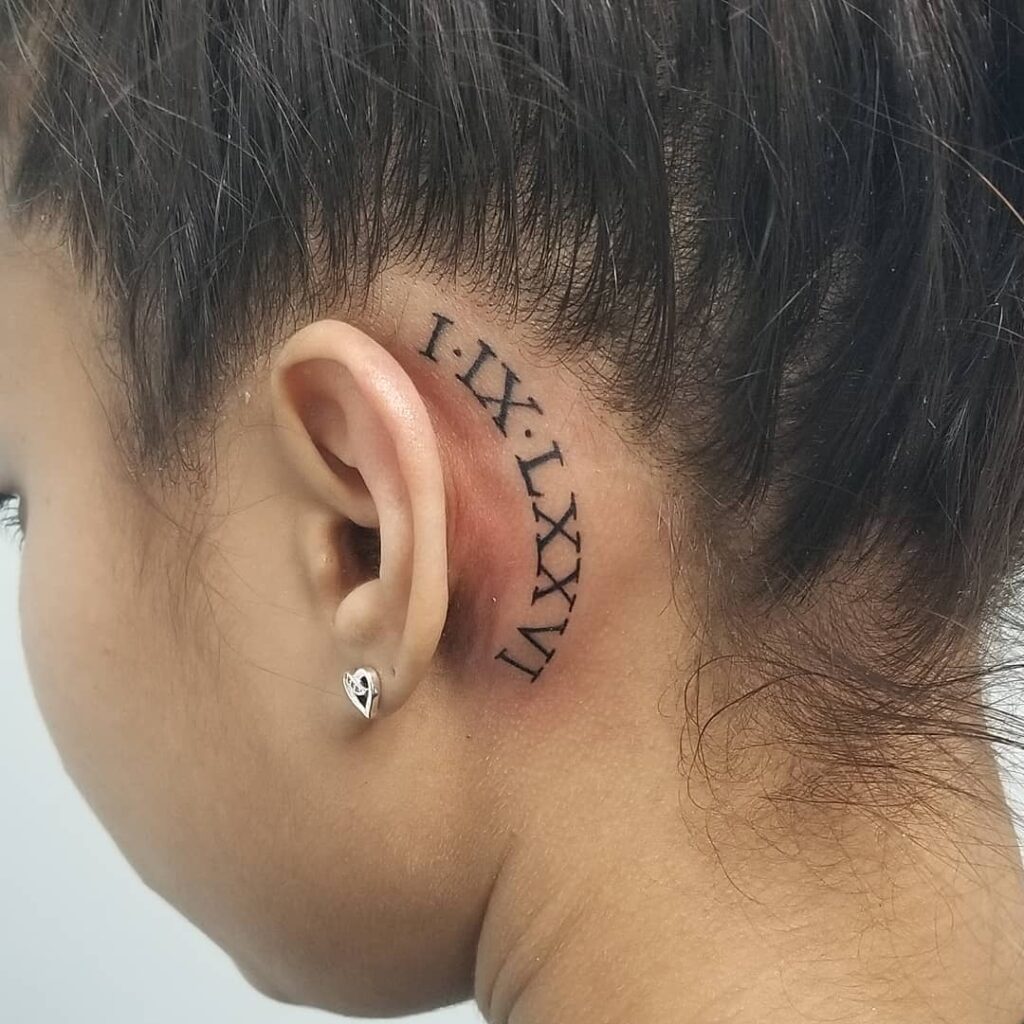 A Roman number behind-the-ear tattoo