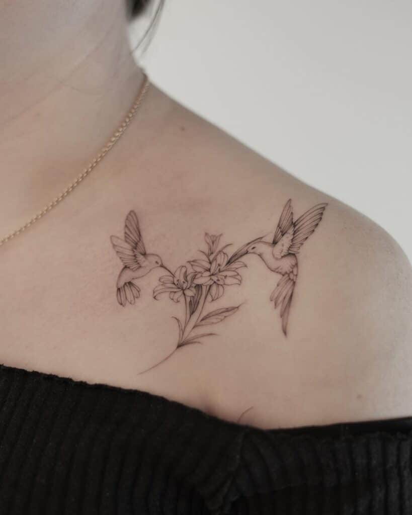 A collarbone hummingbird bird tattoo with flowers