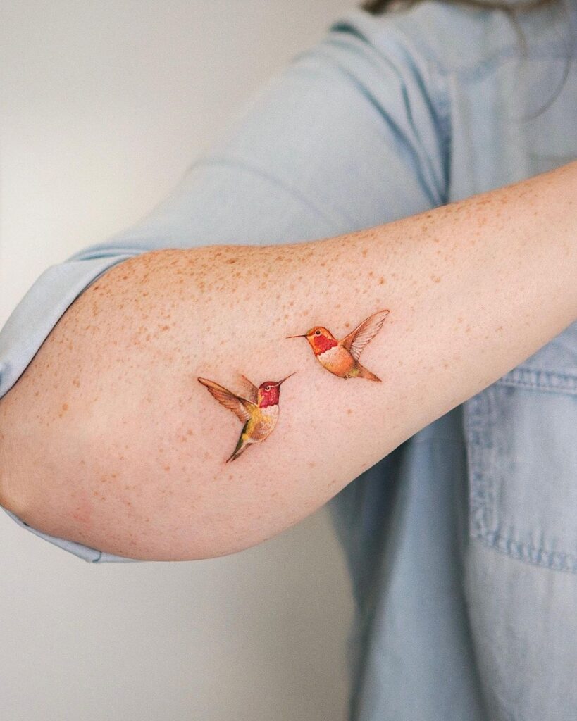 A colorful hummingbird bird tattoo 