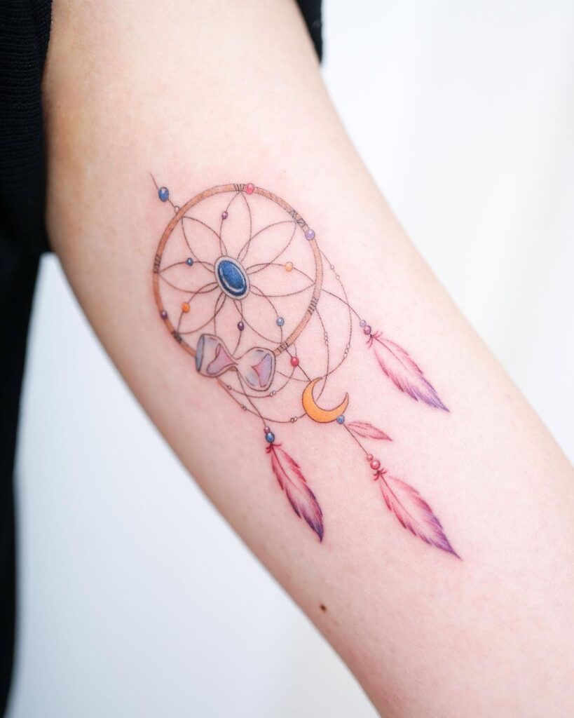 A dream catcher on the inside of the arm