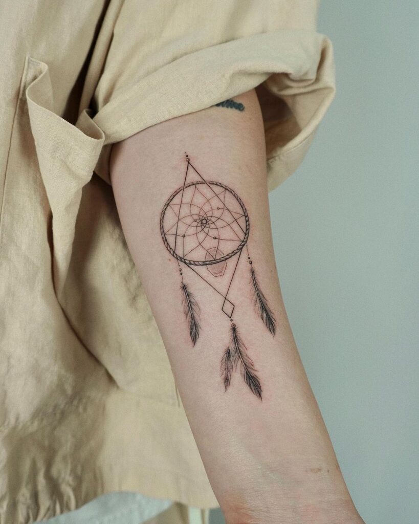 7. A dream catcher tattoo on the arm 
