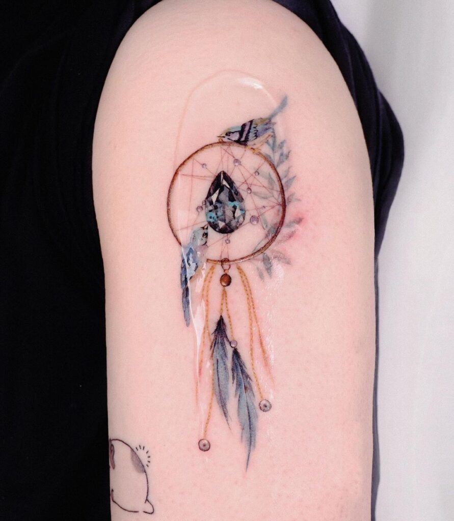 A dream catcher with birds tattoo