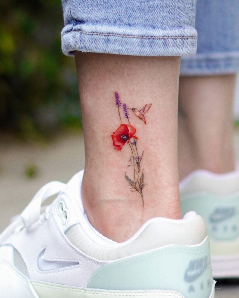 A hummingbird ankle tattoo with flowers