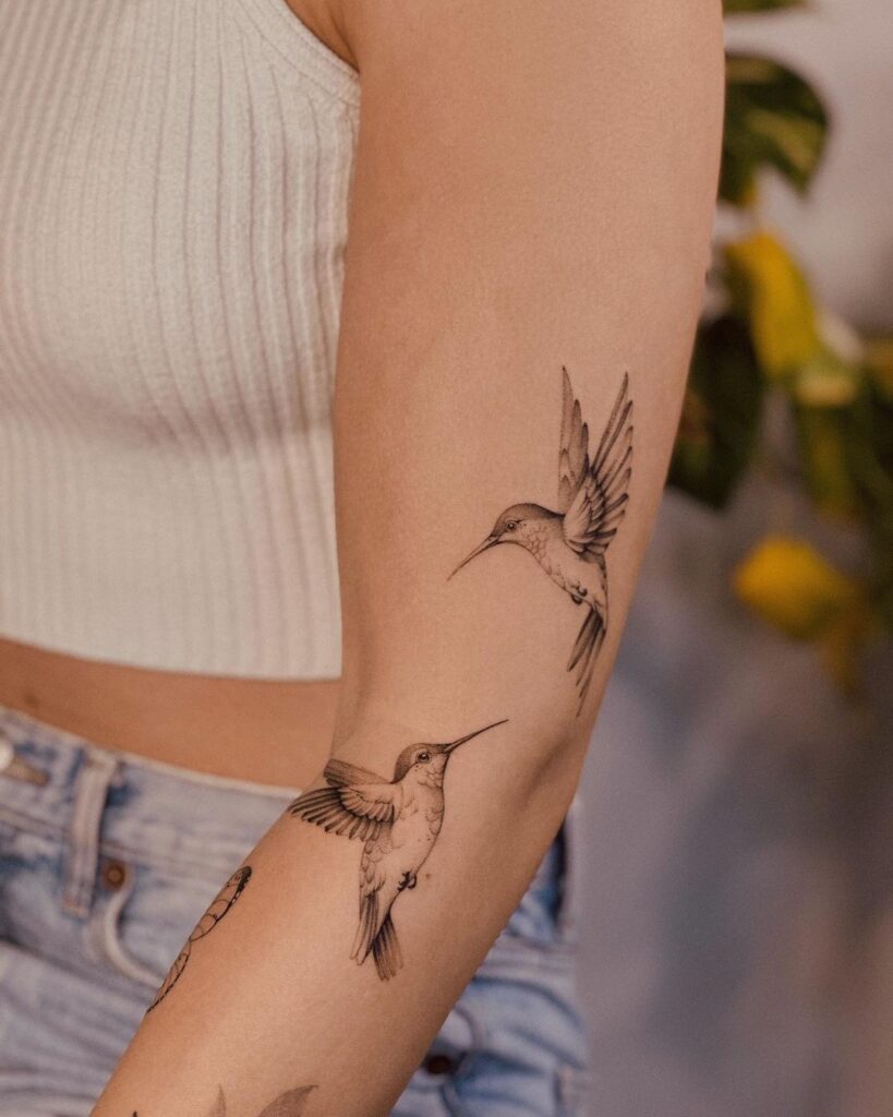 A hummingbird bird tattoo on the arm