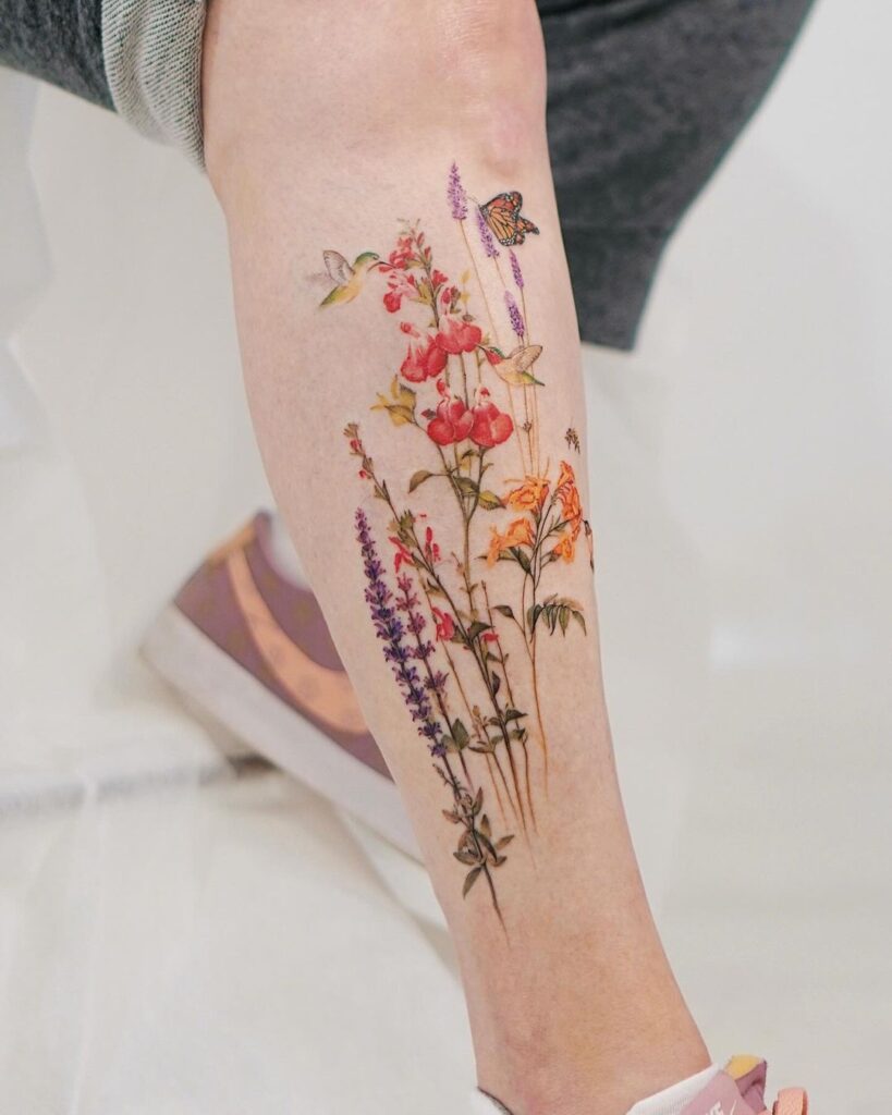 A hummingbird leg tattoo with flowers