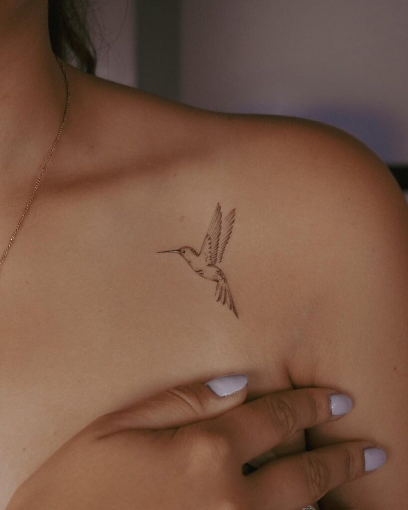 A hummingbird tattoo on the collarbone