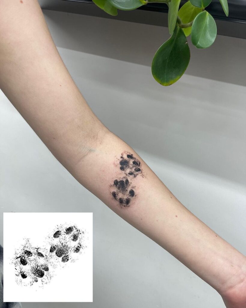 A kitty print tattoo on the forearm