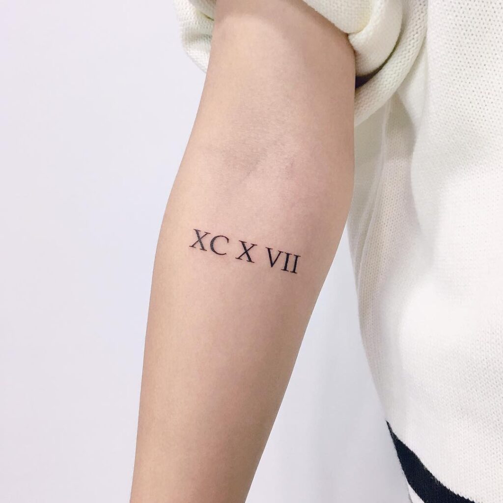 A simple Roman number tattoo on arm