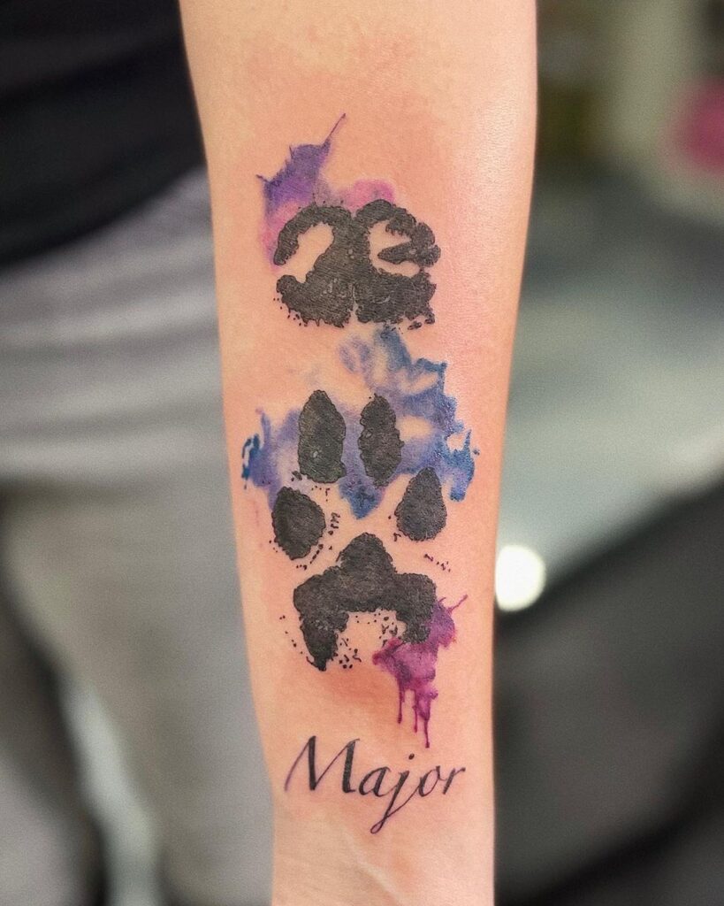 A watercolor paw print and snout print tattoo