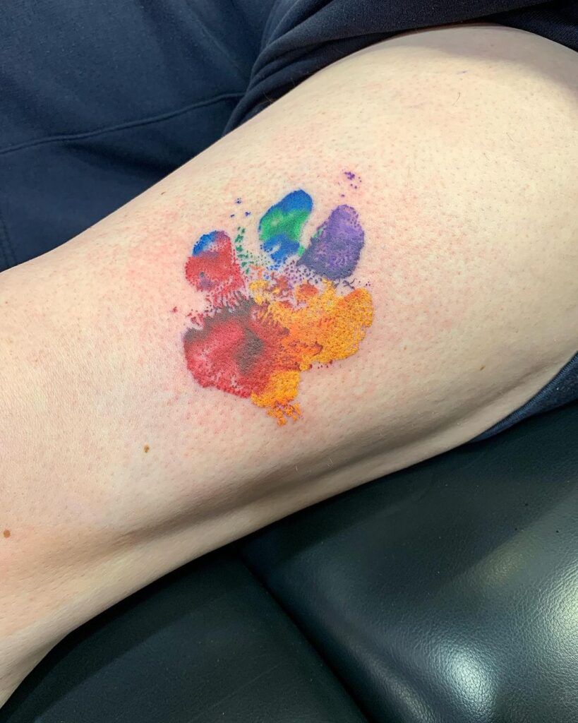 A watercolor paw print tattoo 