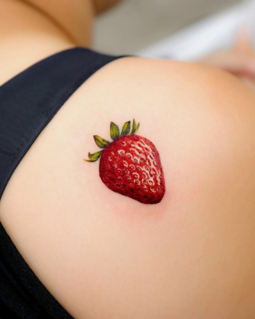 Delicious looking strawberry shoulder tattoo