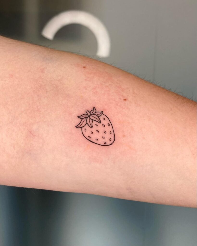 Fine-line strawberry hand tattoo