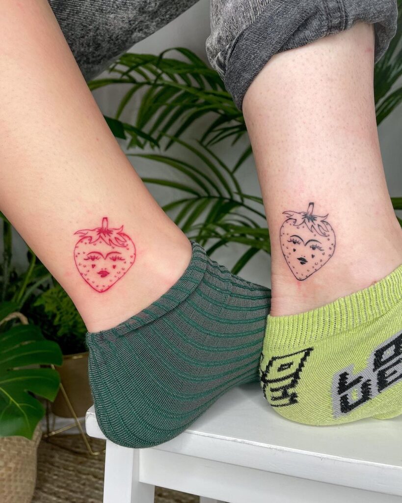 Matching strawberries ankle tattoos