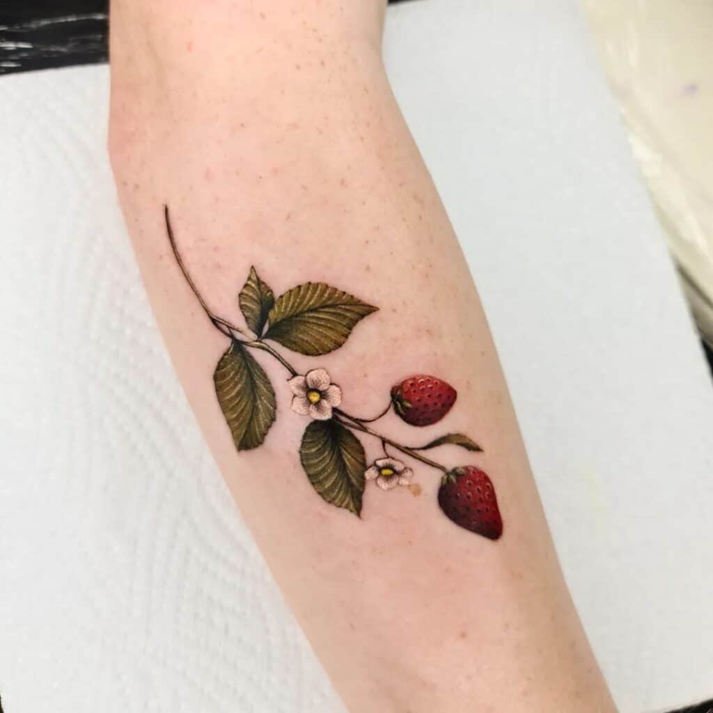 Realistic strawberry tattoo on hand