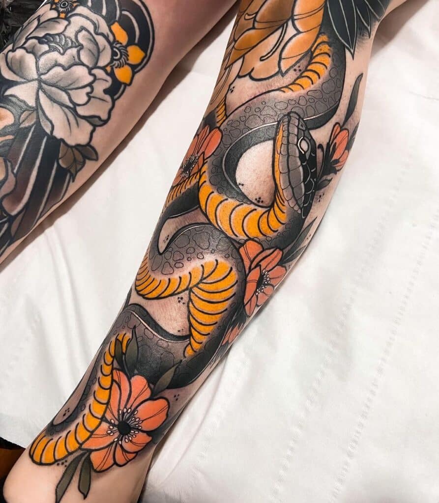 Neo-traditional tattoo showcasing a striking snake design intertwined with orange flowers, featuring the style's signature bold outlines and a dynamic color palette, wrapped elegantly around the arm.
