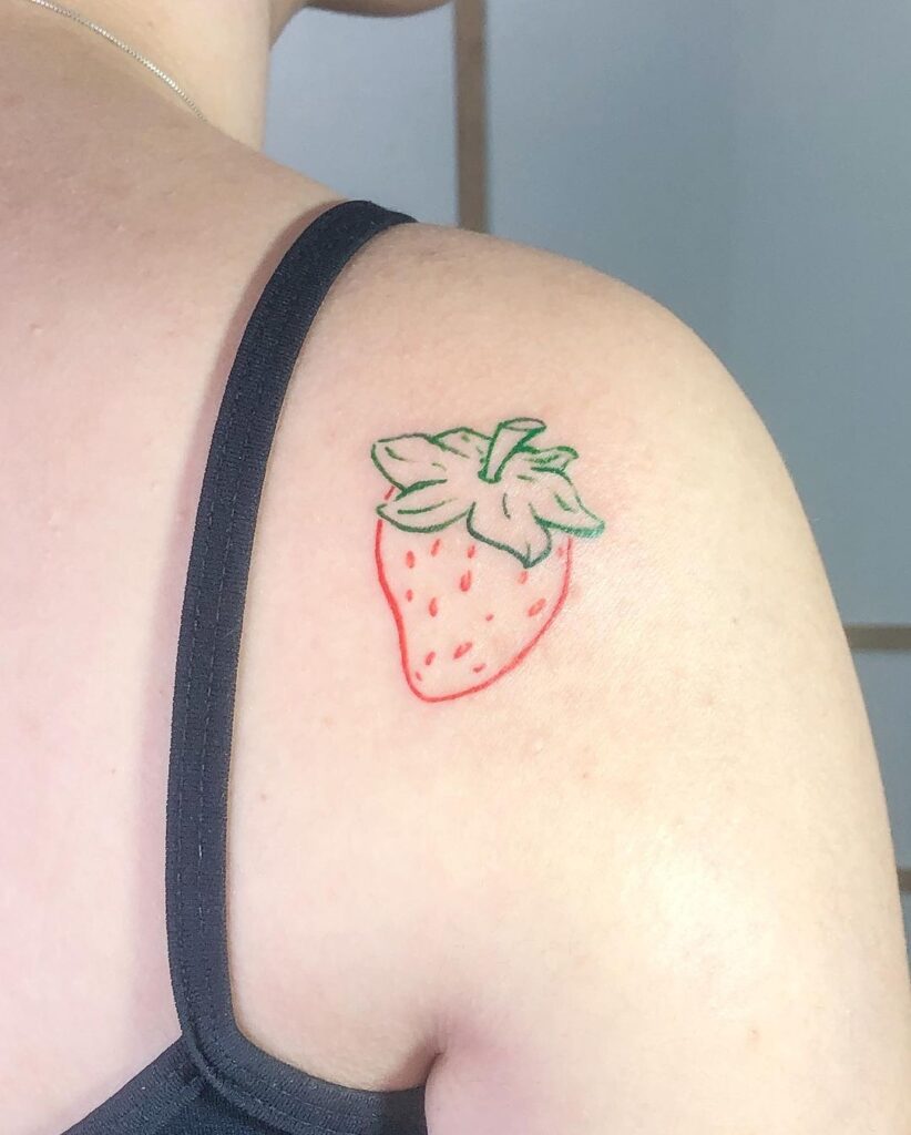 Hand poked strawberry tattoo done with red ink, located