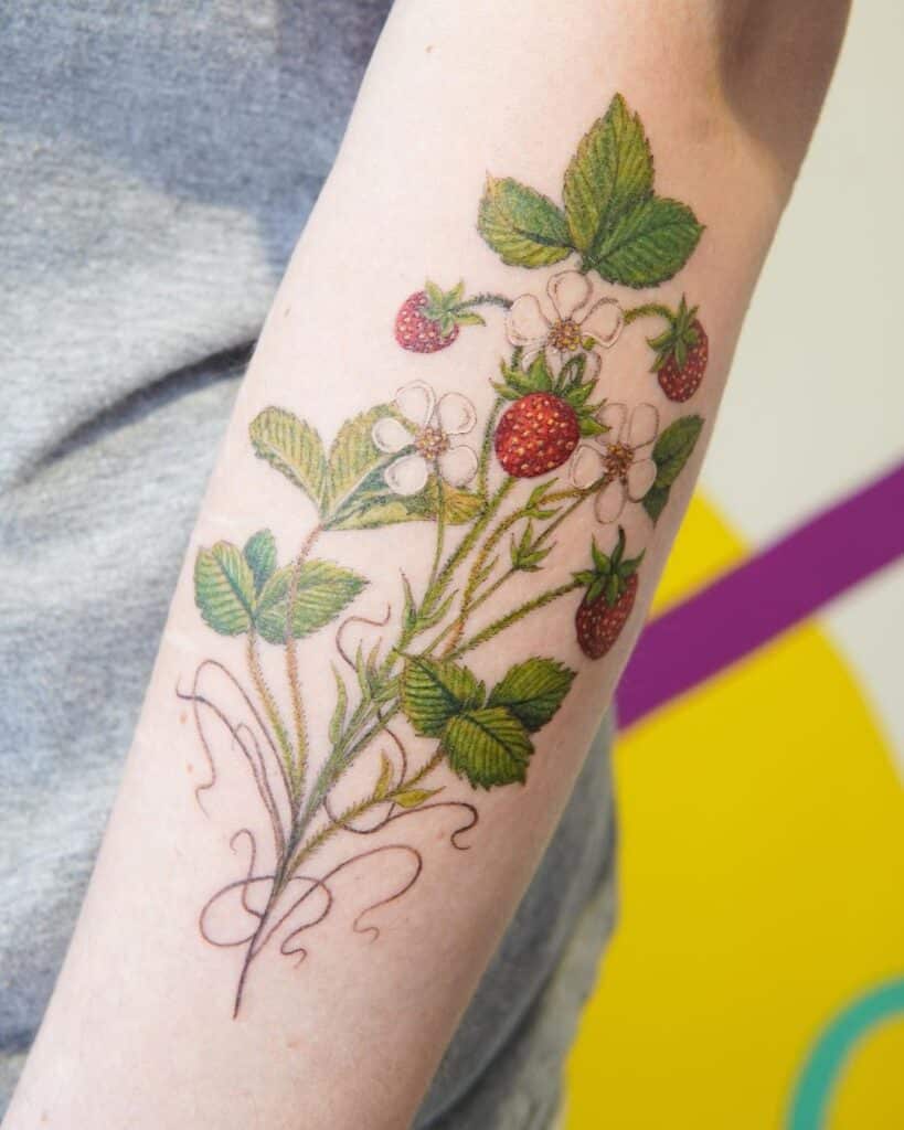 Strawberry plant tattoo on hand
