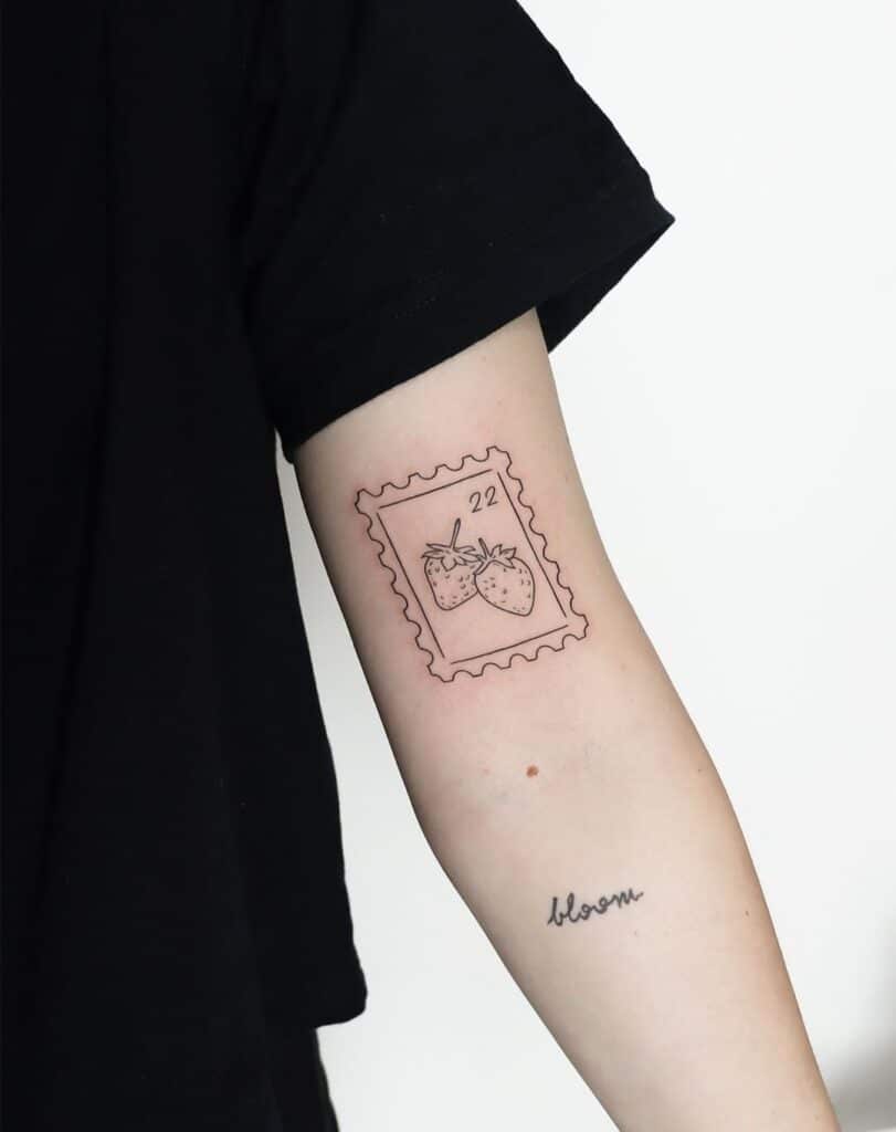 Strawberry stamp tattoo on hand