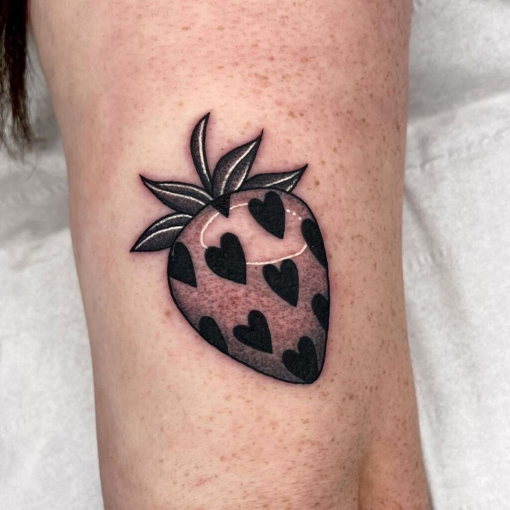 Valentine-inspired strawberry tattoo on hand